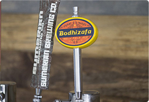 Beer keg tap handles displayed on kegerator